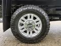 A 2019 Ford F-350 SD wheel featuring a silver alloy rim and a rugged all-terrain tire with pronounced tread