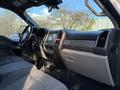 Interior of a 2020 Ford F-350 featuring a large dashboard a central touchscreen display and seating with a grey fabric upholstery
