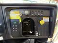 Dashboard of a 2009 International 3000 CE featuring buttons switches a key ignition and warning labels