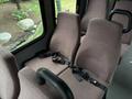 Interior view of a 2014 Ford E-350 showing two cloth seats with seatbelts in a van configuration