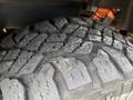 Close-up of a tread pattern on a 2019 Ford F-150 tire showing deep grooves and rugged texture designed for off-road traction