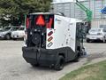 A 2019 Madvac LS175 street sweeper with a compact design featuring a rear-mounted vacuum system and large wheels for maneuverability