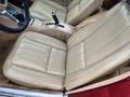 Interior view of a 1970 Chevrolet Corvette featuring light tan leather seats with horizontal stitching and a central console with gear shifter