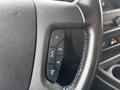 Close-up of the steering wheel of a 2022 GMC Savana featuring control buttons for audio and phone functions