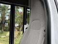 Close-up of the driver's seat of a 2013 Chevrolet Express featuring a textured gray fabric design