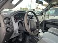 Interior of a 2014 Ford F-250 SD with a steering wheel dashboard and control panels visible