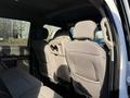 Interior view of the backseat of a 2020 Ford F-350 featuring two headrest-equipped seats with a fold-down armrest and fabric upholstery