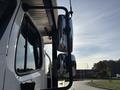 Side mirrors of a 2022 Freightliner M2 106 truck mounted on the driver's side with a chrome finish and a clear reflection