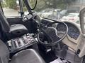 Interior of a 2013 International DuraStar 4300 showing the driver's seat steering wheel and dashboard with various gauges and controls