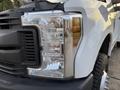 Close-up of the front headlight of a 2018 Ford F-350 showing the reflective lens and chrome details