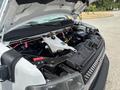 A 2020 Chevrolet Express with the hood open revealing the engine compartment and various components including hoses and a reservoir