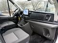 Interior of a 2023 Ford Transit showing two seats and a dashboard with a touchscreen display