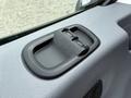 Close-up of the control panel for windows located on the door of a 2017 Ford Transit showing two buttons for operating the windows