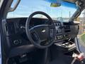 Interior view of a 2019 Chevrolet Express showing the dashboard steering wheel and center console with various controls and a gear shifter