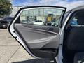 A 2014 Hyundai Sonata with the passenger side door open showing the interior features and upholstery