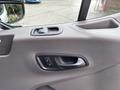 Interior view of a 2020 Ford Transit 250 door panel featuring a handle and window control buttons