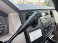 Close-up of the gear shifter for a 2009 Ford F-450 Super Duty featuring a tow haul button and surrounding dashboard controls and gauges