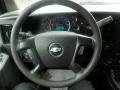 The steering wheel of a 2011 Chevrolet Express featuring the Chevrolet logo in the center and various controls on the sides