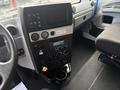 Dashboard of a 2020 Lion Lion6 featuring a digital display climate control knobs various buttons and a cup holder