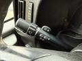 A close-up view of the control stalk in a 2015 GMC Savana showing switch positions for turn signals wipers and headlights