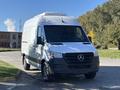 A 2021 Mercedes-Benz Sprinter 2500 van with a white exterior and black accents is parked in the foreground