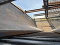 Close-up view of a 2013 International WorkStar truck bed with rusted metal surfaces and visible structural components