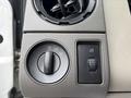 Close-up of the control panel in a 2010 Ford F-550 Super Duty featuring knobs for headlight settings and a switch for fog lights