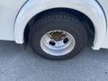 Close-up of a tire and wheel from a 2011 Chevrolet Express showing the wheel rim and tread of the tire
