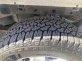Close-up of a rugged tire from a 2017 Ford F-150 showcasing a detailed tread pattern designed for off-road performance
