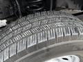 A close-up of a tire from a 2019 Ford F-350 SD showcasing the tread pattern and rubber texture