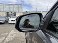 A 2021 Toyota 4Runner is visible with a side mirror reflecting an image of a person and a parking lot in the background