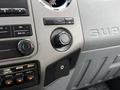 Interior dashboard controls of a 2012 Ford F-550 featuring audio controls and various operational buttons
