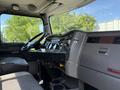 Interior of a 2009 Kenworth T270 featuring a dashboard with controls a steering wheel and seats designed for commercial driving