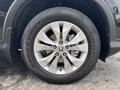 Close-up of the alloy wheel of a 2014 Honda CR-V showing the tire tread and the Honda logo in the center of the wheel