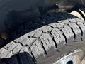 A close-up of a tire from a 2017 Chevrolet Express showing a detailed tread pattern and shiny alloy rim