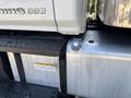 A close-up of a 2020 Hino 338 fuel tank with a silver body and black steps visible next to it