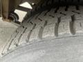 Close-up of a tire from a 2007 Freightliner B2 displaying deeply treaded rubber designed for traction and stability