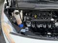 A 2017 Ford Transit Connect with the hood open revealing the engine bay showing various components including hoses and a coolant reservoir