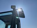 A 2010 Bobcat E80 excavator with a visible side mirror and a work light positioned at the top of the cab