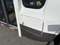 A 2018 Chevrolet Express with a side door showing a keyhole and a white panel with a black lower section