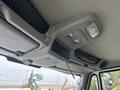 Interior view of a 2013 International WorkStar cab featuring overhead storage compartments and lighting fixtures