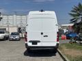 A 2019 Mercedes-Benz Sprinter van viewed from the rear with a plain white exterior and tall, boxy shape