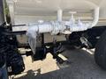 2014 Freightliner M2 106 with white piping and valves connected to a black underside featuring a rear axle and suspension components