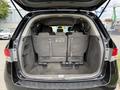 A 2014 Honda Odyssey with a spacious rear trunk showing the folded-down back seats and a clean interior design