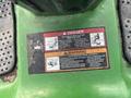 A warning label on a 2021 John Deere L Series mower displaying danger symbols and instructions about the rotating blades and safety precautions
