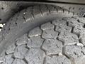 Close-up of the tread on a tire from a 2016 International 7600 showcasing a hexagonal pattern and visible wear on the rubber surface