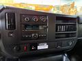 Dashboard of a 2015 GMC Savana featuring radio controls climate knobs and a digital display