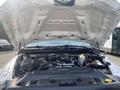 The engine compartment of a 2016 RAM 5500 featuring a large engine with various components including hoses wires and a battery