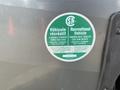 A circular green sticker displaying specifications for a 2013 Outdoor Wind River recreational vehicle and tandem axle trailer information