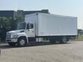 A 2012 Hino 338 delivery truck with a white box cargo area and a silver cab is parked on a street